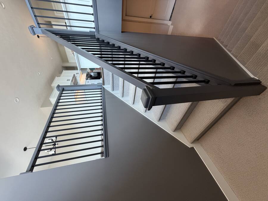 Staircase with charcoal painted walls and black painted railing spindles
