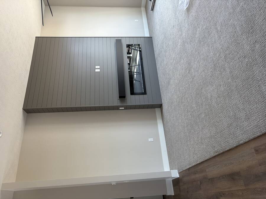 Charcoal painted shiplap accent wall around a fireplace