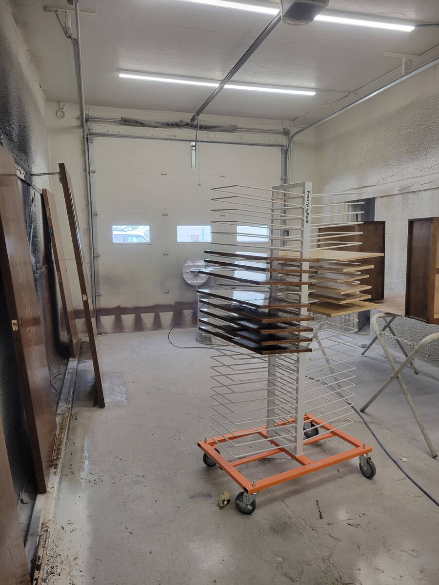 Rack of freshly sprayed cabinet doors and drawer fronts curing in the finishing booth